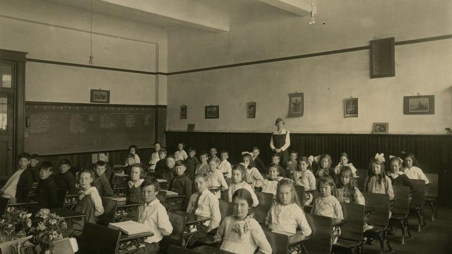 children at desks in classroom in 1922