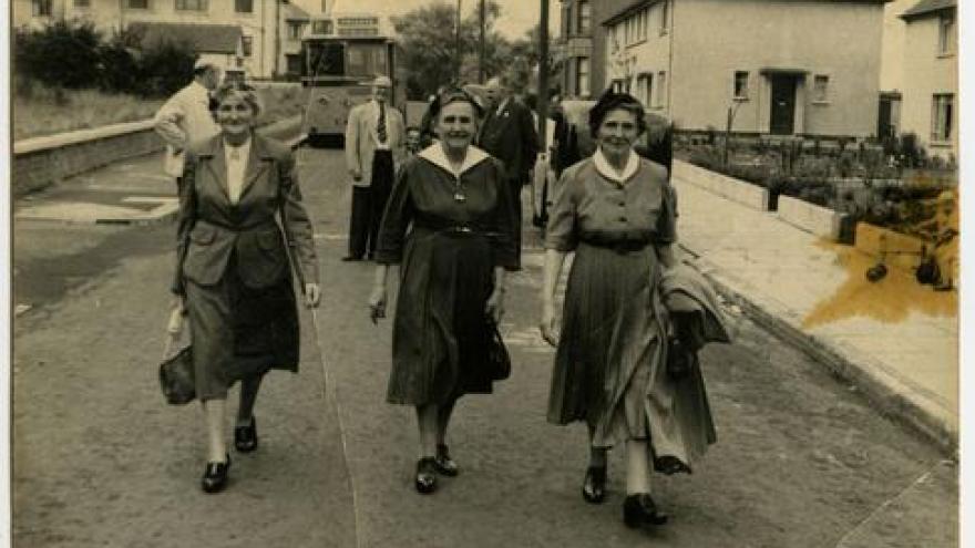 “ Women walking down a street” –Archives photo